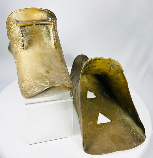 Antique Mexican or Latin American slipper stirrups with decorative Indigenous-inspired motifs.