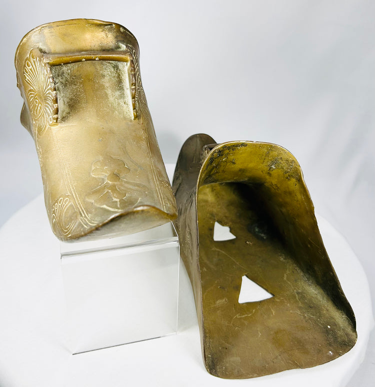 Antique Mexican or Latin American slipper stirrups with decorative Indigenous-inspired motifs.