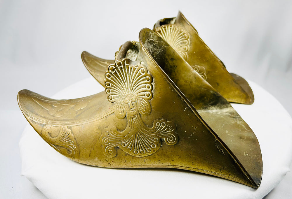 Spanish Colonial riding stirrups with warm aged patina and sculptural enclosed profile.