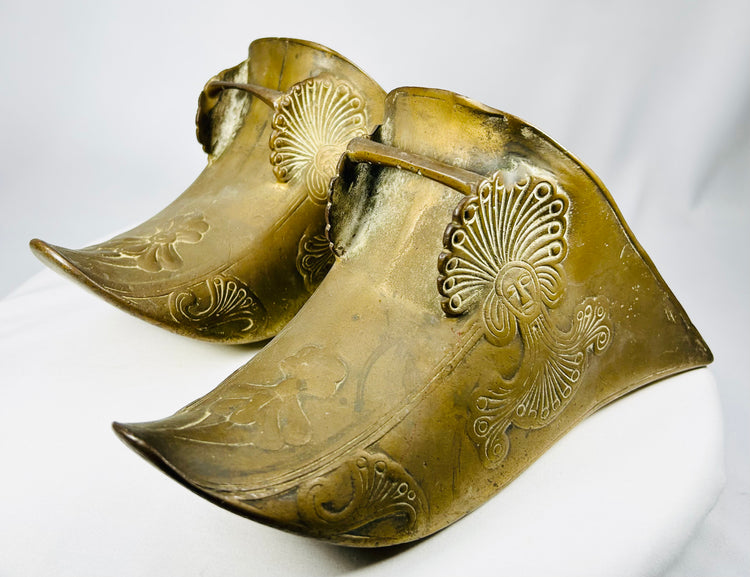Antique equestrian brass slipper stirrups combining Colonial and Indigenous artistic influences.