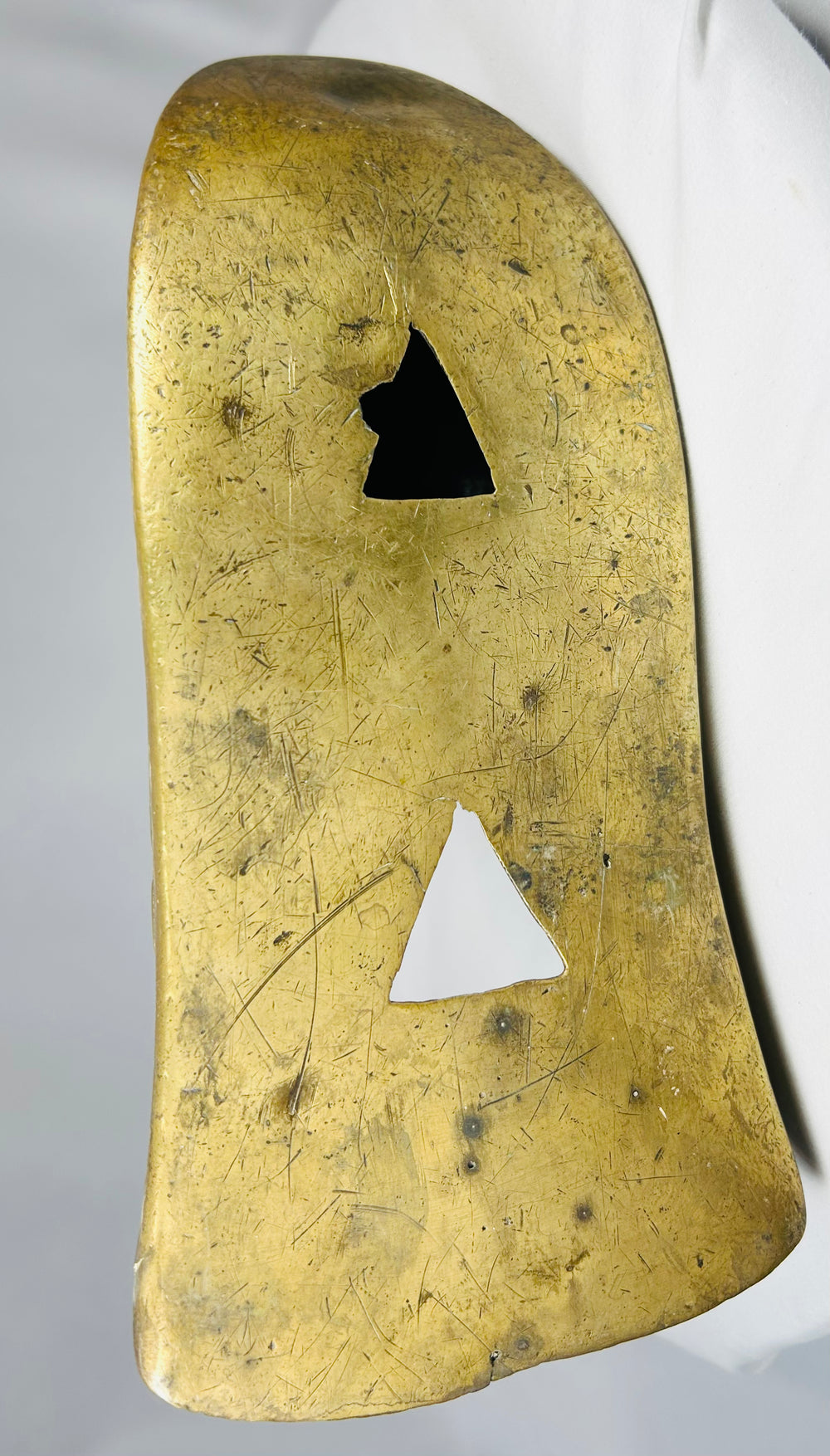 Antique cast brass slipper stirrups with enclosed toe and relief ornamental detailing.