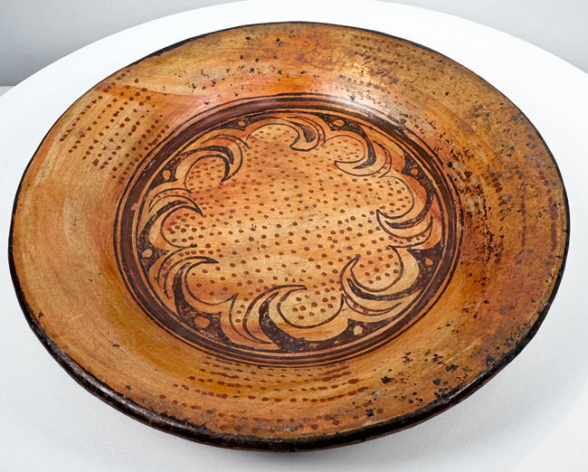 Side perspective of ancient Greater Nicoya pottery plate showing broad shallow form and raised rim