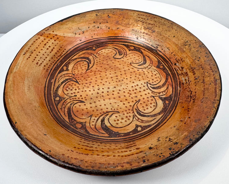 Side perspective of ancient Greater Nicoya pottery plate showing broad shallow form and raised rim