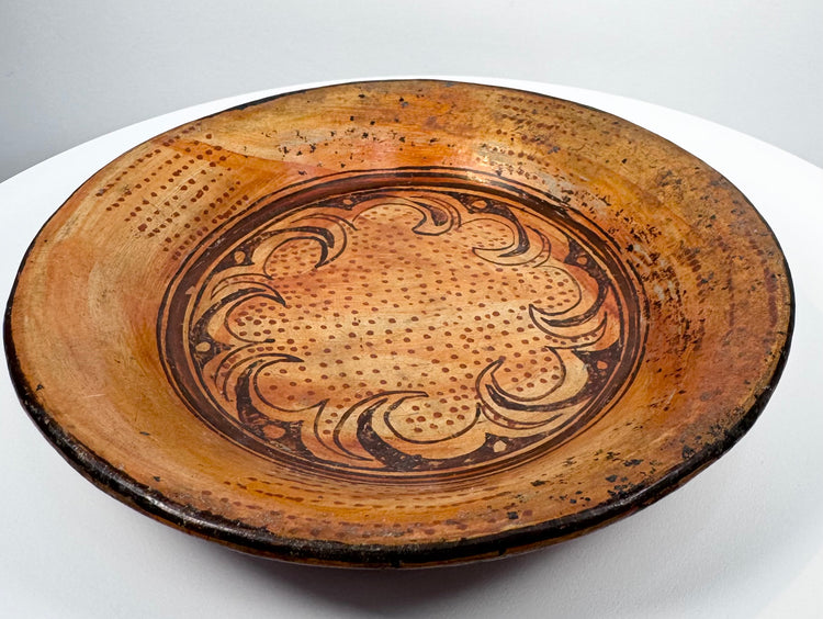 Detailed view of Pre-Columbian painted ceramic bowl with dotted field and inward-curving scroll motifs