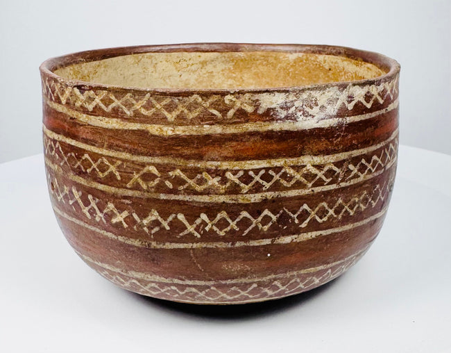 Rounded ceramic bowl with linked diamond bands and contrasting cream-colored lines.