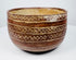 Rounded ceramic bowl with linked diamond bands and contrasting cream-colored lines.