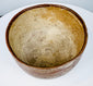 Geometric earthenware bowl with a broad open mouth and worn painted decoration.