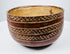 Painted earthenware bowl with rounded sides and a contrasting light-colored interior.
