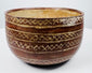 Decorated earthenware bowl with repeating X-shaped motifs and a pale buff interior.