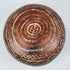 Ceramic bowl underside with concentric rings surrounding a central geometric motif.
