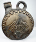 Circular Andean ceramic vessel with stylized face and ceremonial plumage motifs