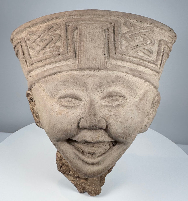 Classic Veracruz Sonriente terracotta head with expressive smile and elaborate geometric headdress