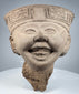 Pre-Columbian Veracruz ceramic head with broad open smile and ceremonial headdress decoration
