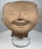 Pre-Columbian Veracruz Sonriente sculpture with open smiling mouth and raised headdress decoration