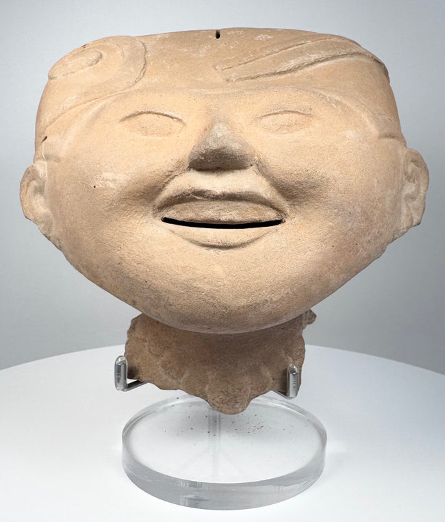 Ancient Mexican smiling face ceramic head from Veracruz with rounded cheeks and gently narrowed eyes