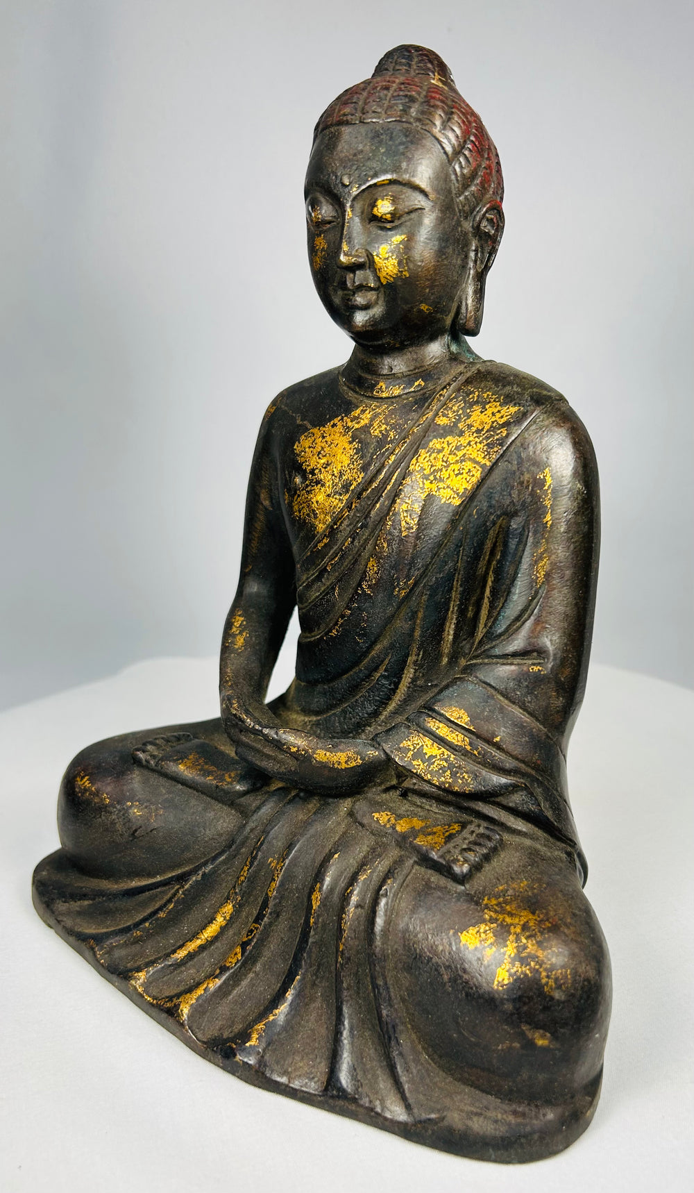 Ming–Qing period seated Buddha bronze sculpture with red lacquer traces