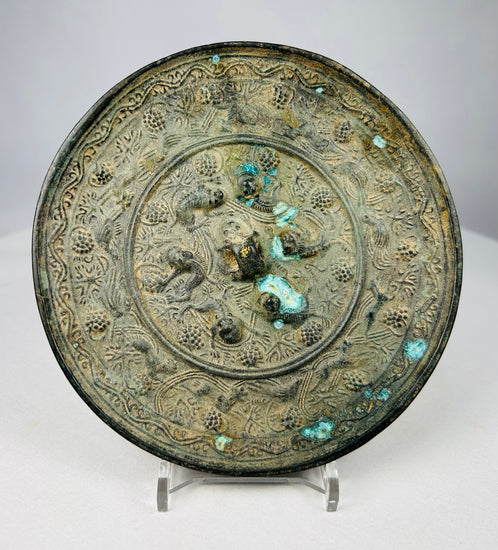 Chinese Tang style bronze mirror with raised marine creature decoration