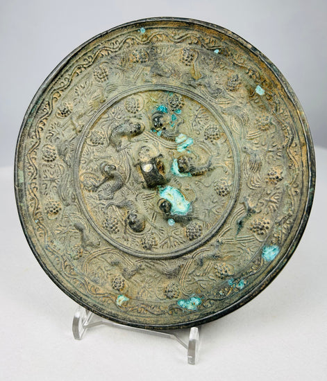 Circular Chinese bronze mirror with ornate reverse and natural patina
