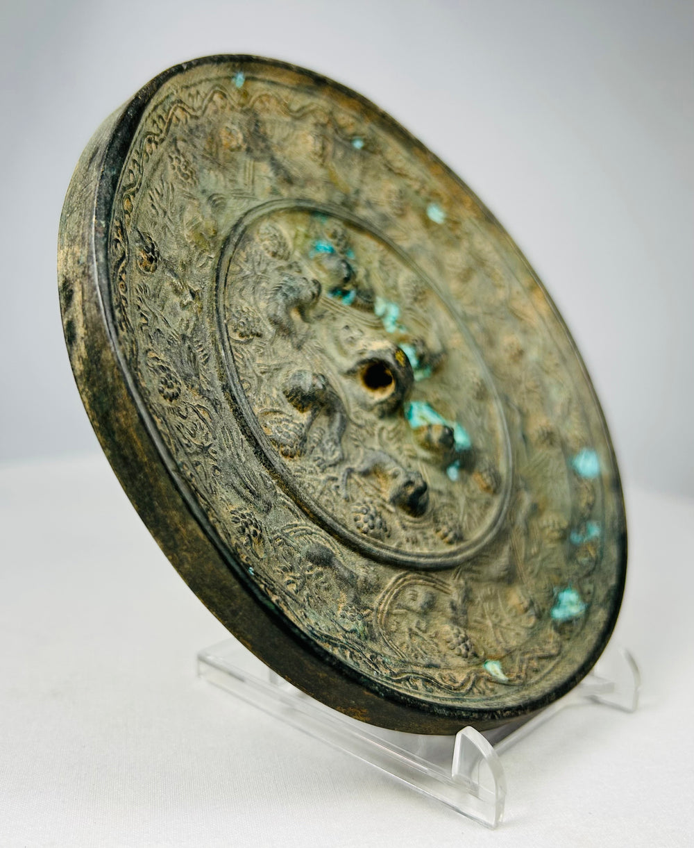 Chinese bronze mirror displaying intricate sea creature ornamentation