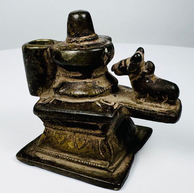 Indian brass Shaivite shrine featuring a Shiva Lingam, yoni-pitha, and recumbent Nandi bull, circa 19th century.