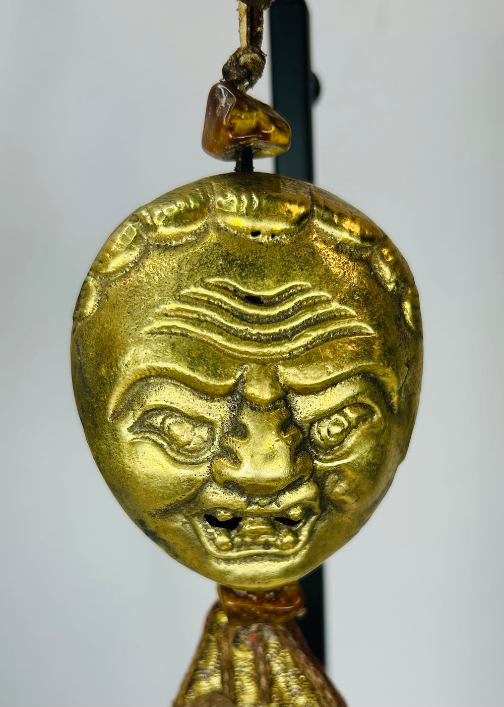 Himalayan gilt bronze ritual mask pendant with textile tassels