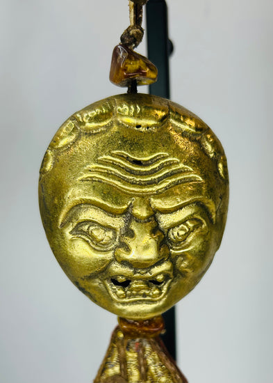 Himalayan gilt bronze ritual mask pendant with textile tassels