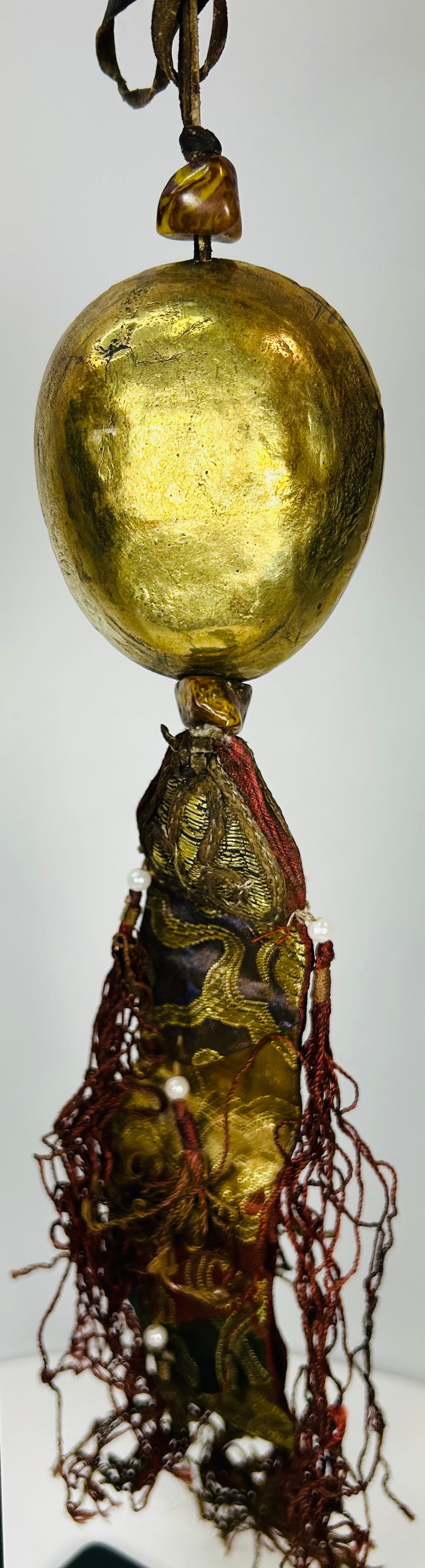 Tibetan devotional pendant featuring protective deity mask