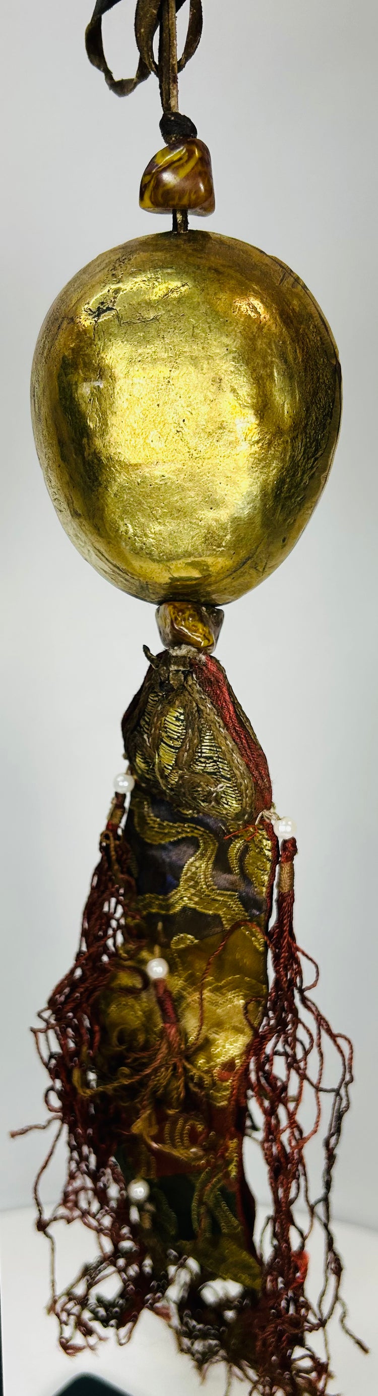 Tibetan devotional pendant featuring protective deity mask