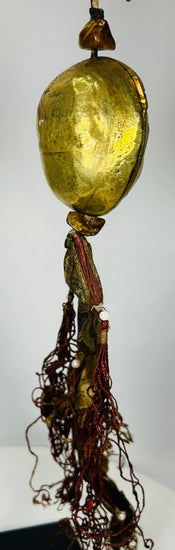 Gilt bronze Tibetan guardian mask with traditional textile suspension