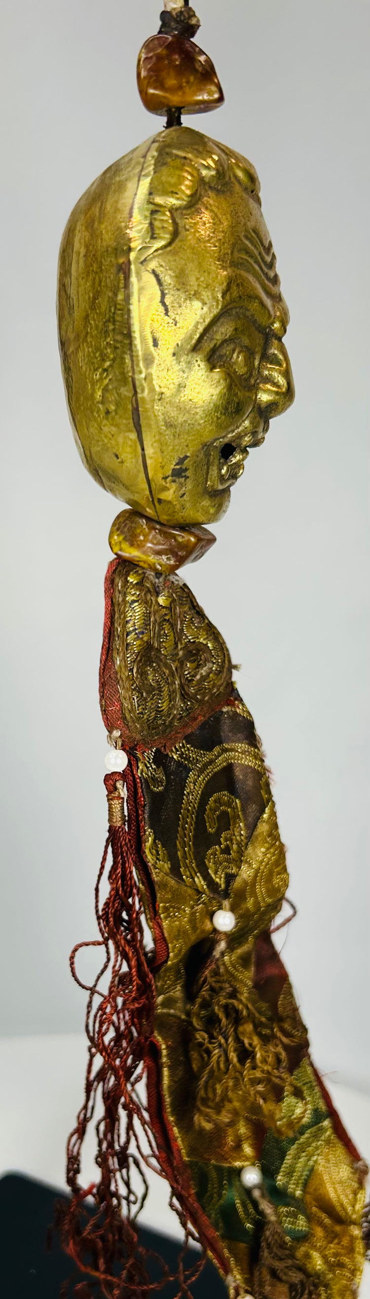 Himalayan Buddhist hanging ornament with tassels and bronze mask