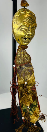 Tibetan ritual pendant with gilt bronze mask and aged textiles