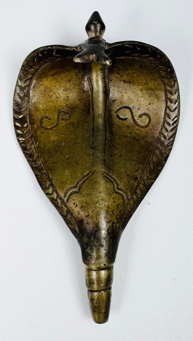 19th century Indian Hindu shrine fitting depicting an expanded Naga cobra hood in cast brass.
