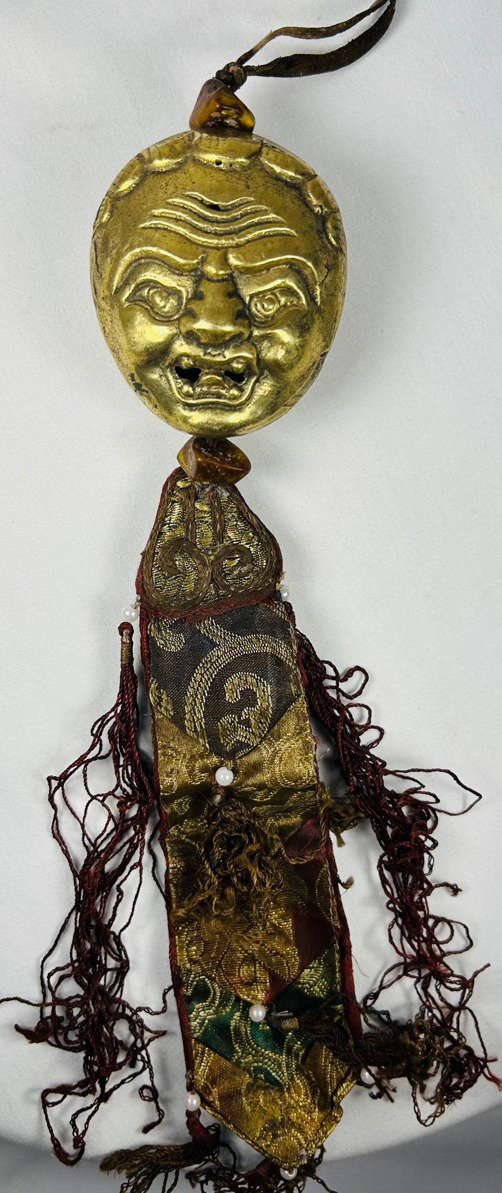 Antique Tibetan devotional hanging with gilt bronze protective mask