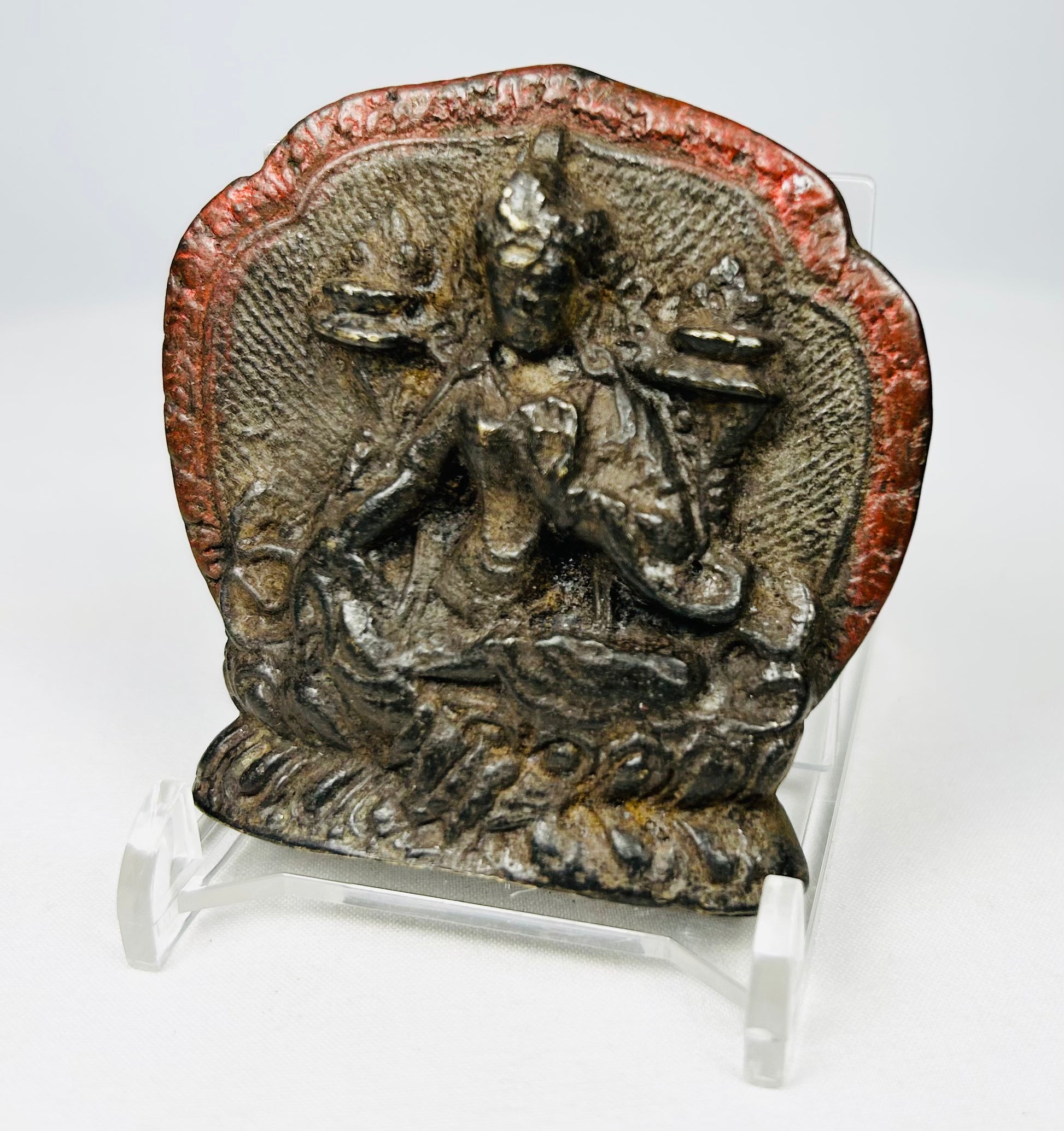Himalayan bronze shrine plaque with haloed deity figure