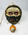 Tibetan protective mask amulet in traditional devotional style