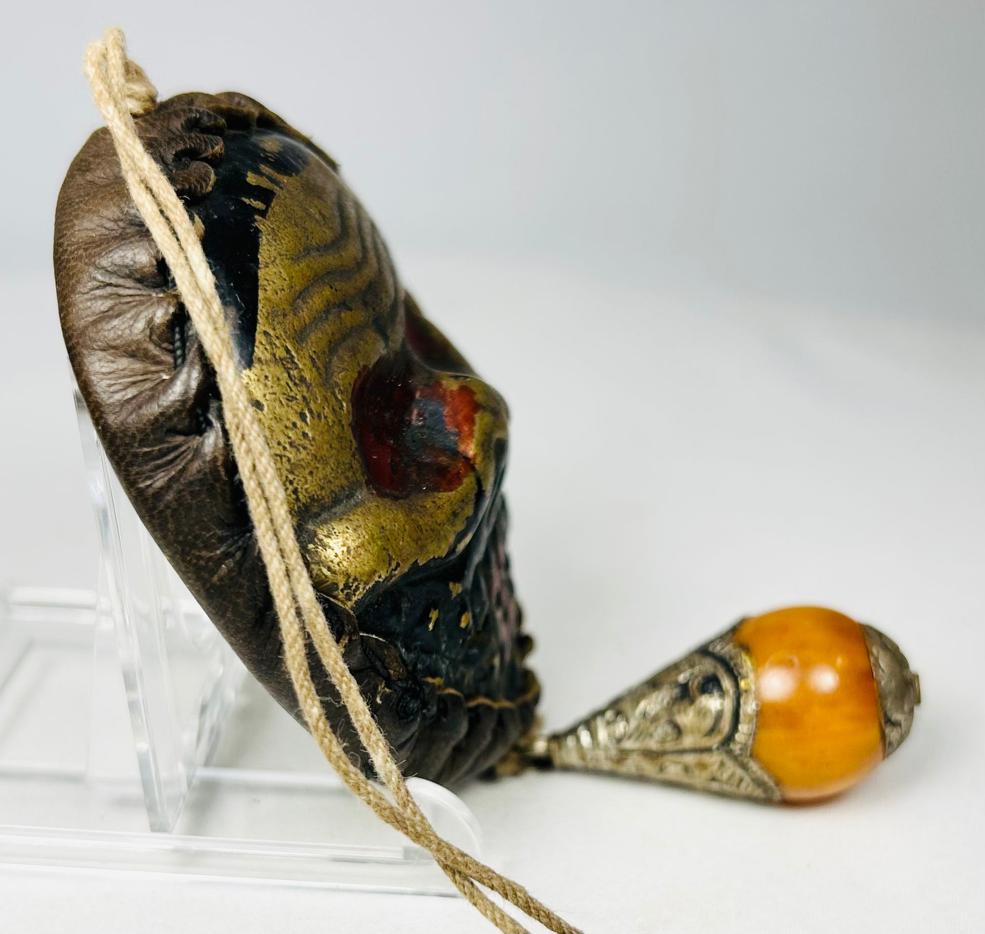 Protective Himalayan skull mask with textile cord suspension