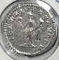 Reverse of a Roman silver denarius of Septimius Severus with standing figure, surrounding legend and preserved silver surface.