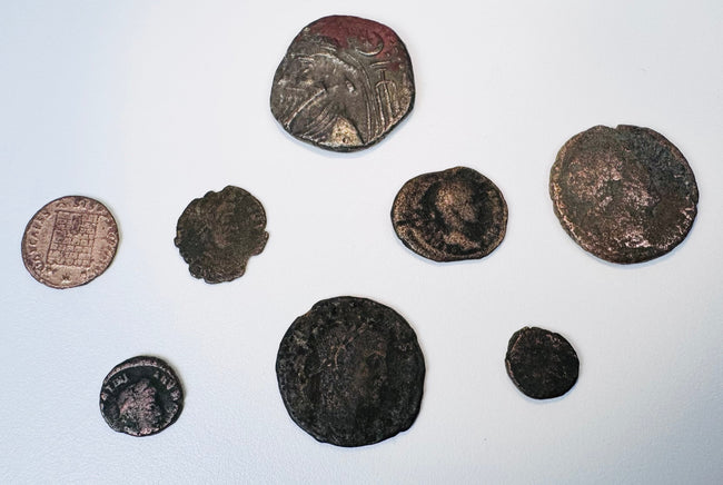 Group of ancient and medieval silver and copper-alloy coins showing varied portraits, figures, patinas and surface wear.