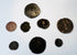 Selection of ancient copper-alloy and silver coins from the collection showing varied sizes, portraits and historic patinas.