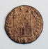 Close-up of a Late Roman copper-alloy camp-gate type coin, likely Constantinian era, with fortified gateway reverse.