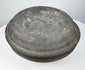 Ancient Chinese gray pottery covered box viewed from above, highlighting the broad domed cover and dark aged surface.