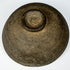 Underside of an ancient Chinese gray pottery bowl showing the circular foot, unglazed earthenware surface, and historic wear.