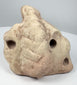 Ancient Caribbean three-pointed stone zemi with sculpted base, central projection, and carved recesses.