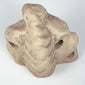 Taíno carved stone ritual sculpture with cream, buff, and pinkish coloration and aged surface wear.