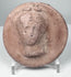Ancient Eastern Mediterranean terracotta appliqué with idealized female head, possibly from an Asia Minor workshop tradition.