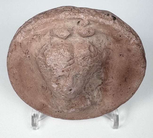 Ancient Greek mould-made terracotta roundel depicting an idealized female figure, circa 2nd–1st century BCE.