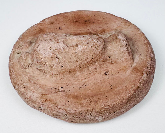 Ancient Eastern Mediterranean terracotta medallion with female bust in high relief and weathered surface.