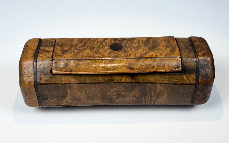 19th-century English treen snuff box in richly figured burr walnut with ebony-style banding and hinged lid.
