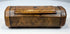 19th-century burr walnut tobacco snuff box with hinged cover, rounded terminal sections, and natural wood figuring.