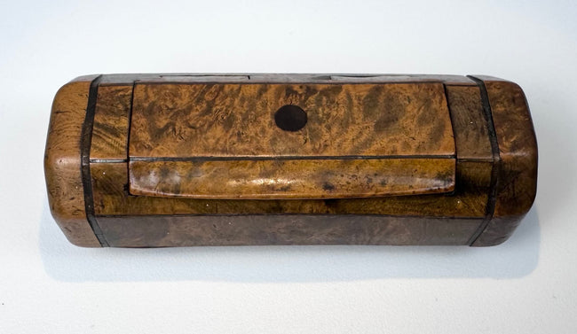 Early Victorian burr walnut pocket snuff box with canted corners, dark stringing, and warm golden-brown patina.